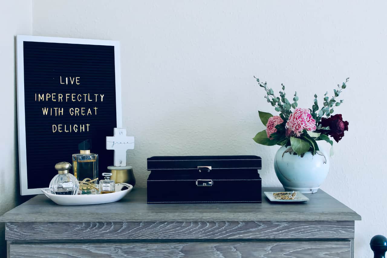 imperfect Image of Desktop with a plaque saying Live Imperfectly with Great Delight